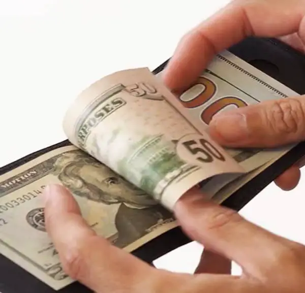 cash bills in a Airo Collective Stealth Leather wallet
