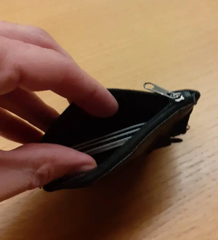 an open minimalist wallet with a few cards in it