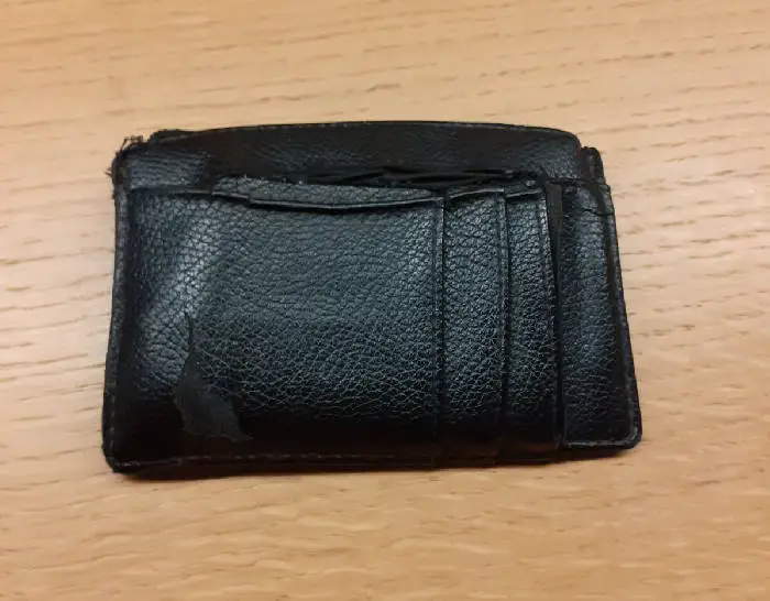 top view of an old black minimalist leather wallet
