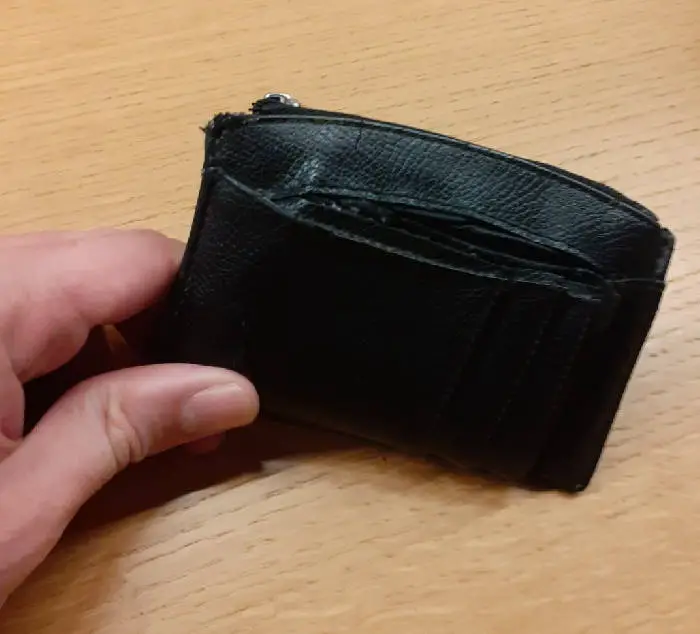 diagonal view of a hand holding a minimalist wallet