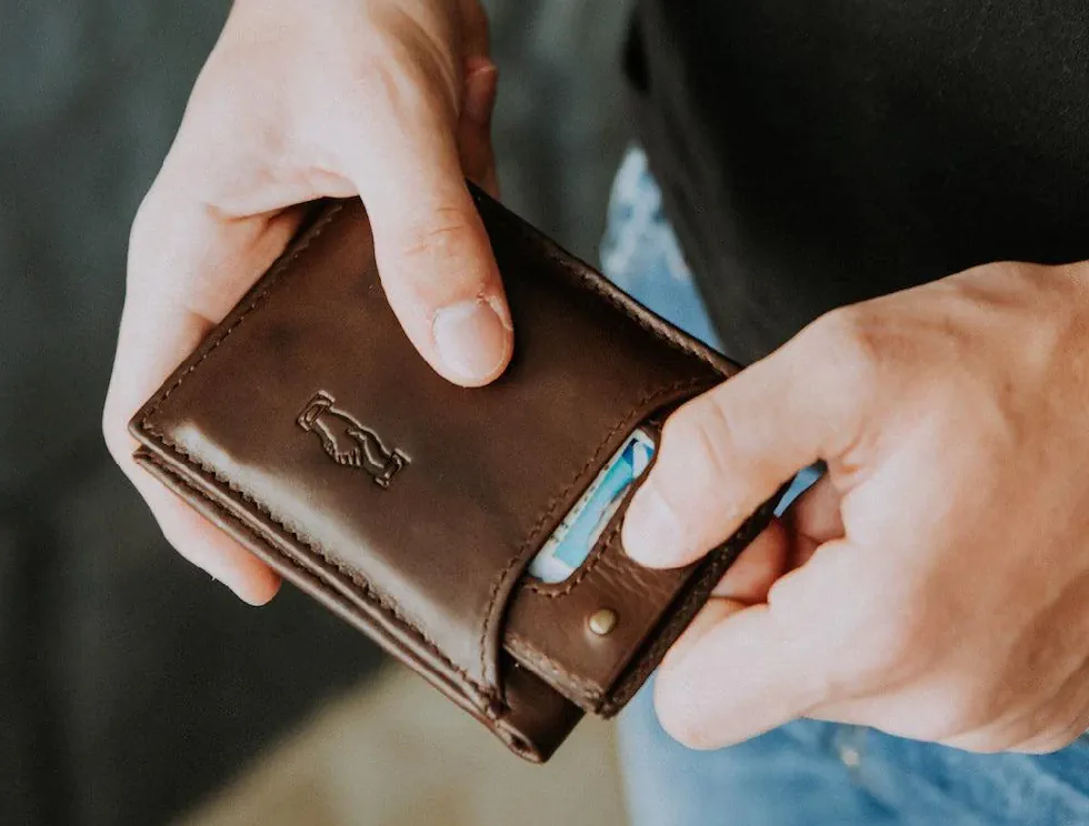 person holding a front pocket wallet