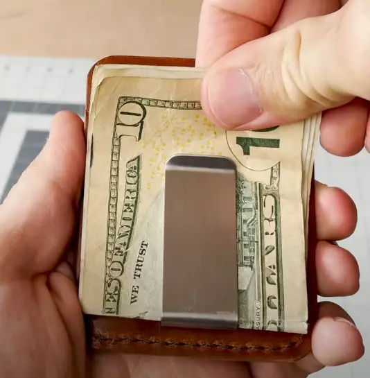 tucking bills in money clip