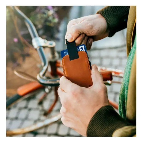 Wally Micro wallet in hands in front of bike